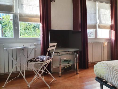 TV a/nebo společenská místnost v ubytování Chambre double accueillante avec douche privative