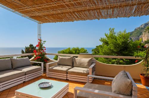 a patio with a view of the ocean at Oliveto Capri apartments in Capri