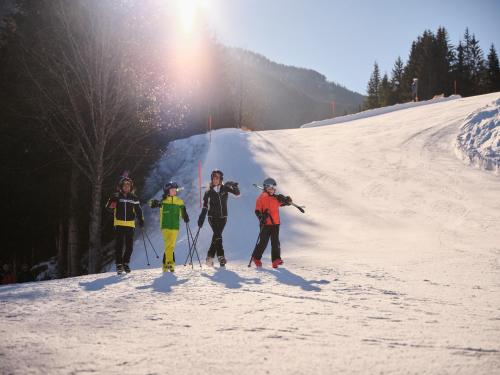 a group of people standing on a snow covered slope at Sporthotel Wagrain in Wagrain