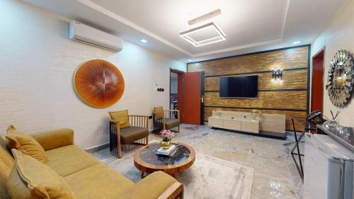 a living room with a couch and a tv at YANNA APARTMENT BY KHALIQUES in Abuja