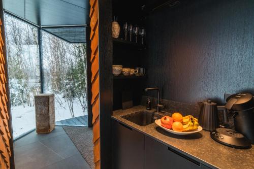 a kitchen with a plate of fruit on a counter at Maidla Nature Resort in Maidla