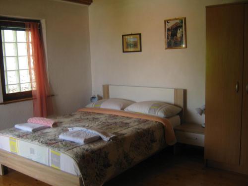 a bedroom with a bed with two pillows on it at Risto's Guest House in Ohrid