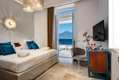 a bedroom with a bed and a view of the ocean at GOCCE VILLAS - Villa Degli Dei Waterfront Villa in Vico Equense