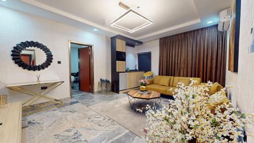 a living room with a couch and a table at YANNA APARTMENT BY KHALIQUES in Abuja