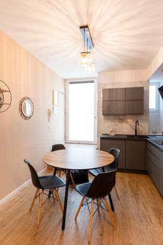 a dining room with a table and chairs in a kitchen at THE BASEMENT in Milan