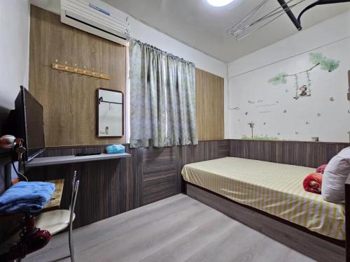 a bedroom with a bed and a television in it at Peace 28 B&B in Jincheng