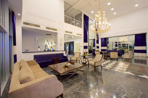 a living room with a couch and chairs and a table at Ramada By Wyndham Soma in Soma