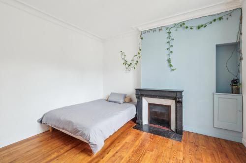 une chambre avec un lit et une cheminée dans l'établissement Spacious apartement 'Canal Saint Martin' for 6 by Weekome, à Paris
