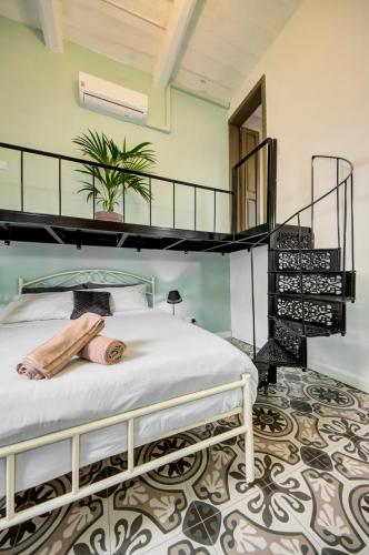a bedroom with a white bed with a black bunk at Boho Rooms Sliema in Sliema
