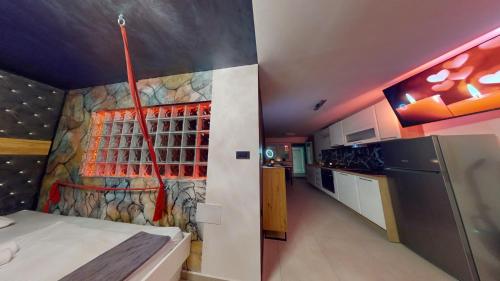 a kitchen with a wall with a painting on it at Resort TimAJA - pool, massage pool, sauna in Trebnje