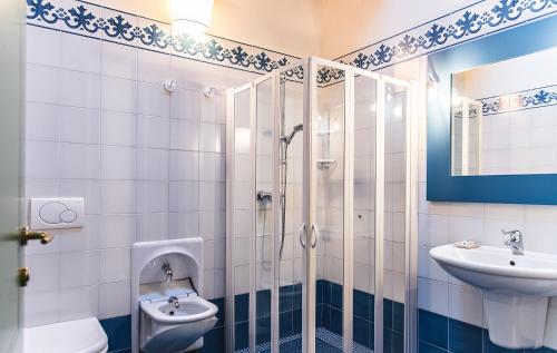 a bathroom with a shower and a sink and a toilet at Corte San Mattia in Verona