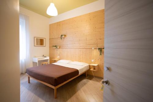 a bedroom with a bed and a wooden wall at B&B In Natura in Salerno
