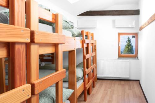 a group of bunk beds in a room at Ribniška koča in Ribnica na Pohorju