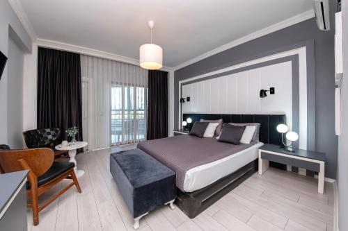 a bedroom with a bed and a desk and a chair at Expo Park Hotel in Antalya