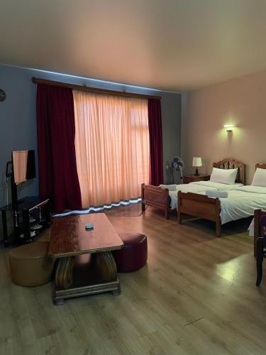 a hotel room with a bed and a table at Hotel ERA in Tbilisi City