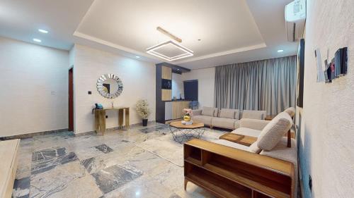 a living room with a couch and a table at YANNA APARTMENT BY KHALIQUES in Abuja