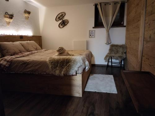 a bedroom with a dog sitting on a bed at Le chalet du village in Chambave