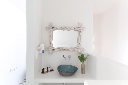 a bathroom with a sink and a mirror at Aeolos Villas Sustainable Living in Agkidia