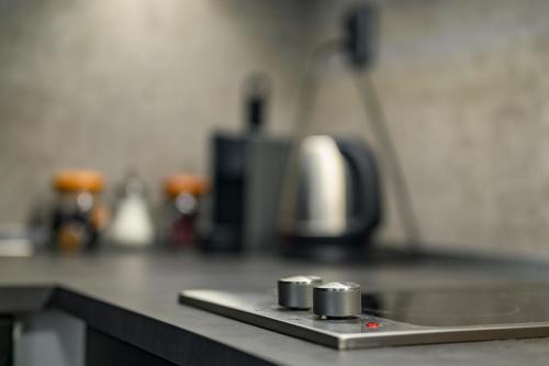 a counter in a kitchen with a counter top with a stove at black well in Jablonec nad Nisou
