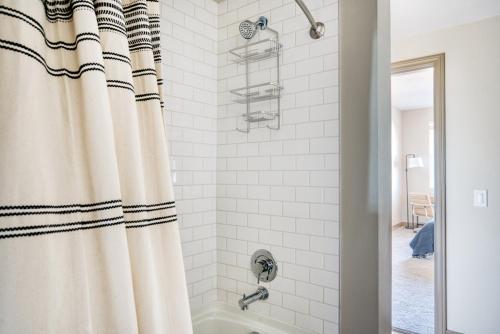 a bathroom with a shower curtain and a tub at Burlingame 1br w wd gym roof nr Caltrain SFO-1155 in Burlingame