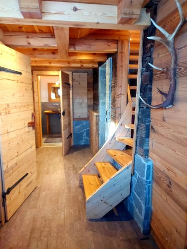 an inside view of a tiny house with stairs at Chalet Troadkasten Biohof Kreilgut in Walchegg