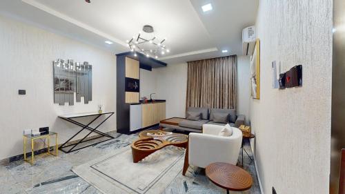 a living room with a couch and a table at YANNA APARTMENT BY KHALIQUES in Abuja