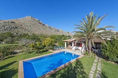 a swimming pool in a yard with a house at Villa Can Deyá in Port de Pollensa