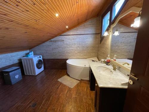 a bathroom with a tub and a toilet and a sink at SOFIA APARTMENTS in Thessaloniki