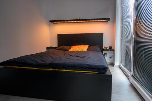 ein Bett in einem Schlafzimmer mit einem großen Fenster in der Unterkunft black well in Jablonec nad Nisou