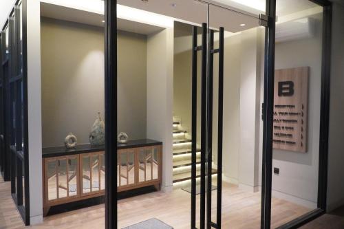 a room with glass doors and a stair case at Posto Dormire Sudirman in Jakarta