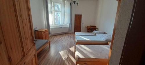 a room with two beds and a window at Penzión Sandrik in Hodruša