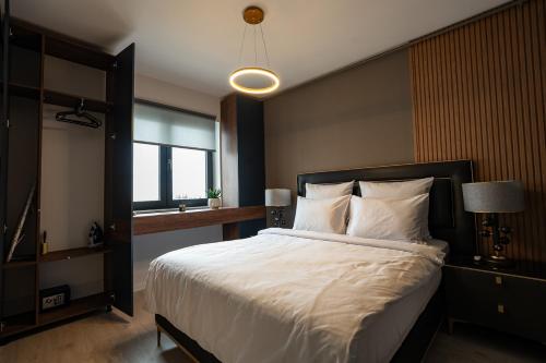 a bedroom with a large bed and a window at Blvd Ivory Pipera ap.62B in Bucharest