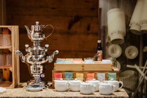 a silver trophy sitting on top of a table with tea cups at Gästehaus Fritz in Mittelberg