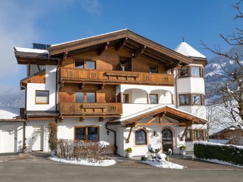 a house in the mountains with snow at Appartementhaus Fuchs in Itter
