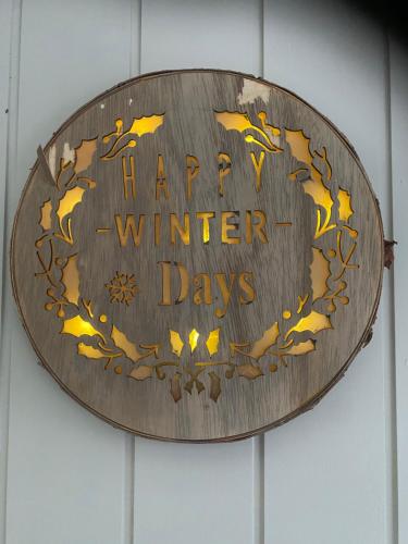 a wooden sign that says winter days at Chalet Sint-Hubertus in Zutendaal