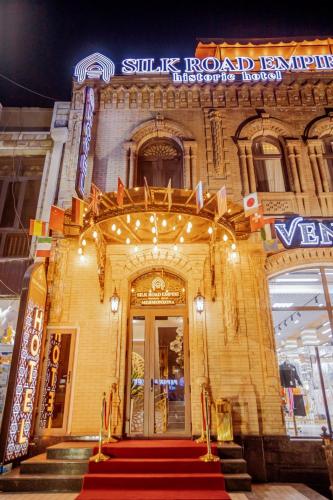 a building with a red carpet leading to a door at HOTEL SILK ROAD EMPIRE SAMARKAND in Samarkand