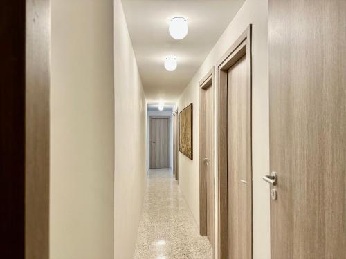 a hallway with white walls and a door and a hallway with a corridorngthngth at Apartments Navigli in Milan