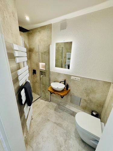 a bathroom with a toilet and a sink at Landloft in Oberteuringen