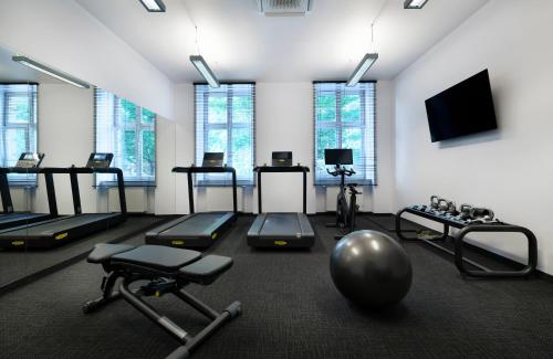 a gym with a bunch of exercise equipment in a room at Leonardo Boutique Hotel Krakow Old Town in Krakow