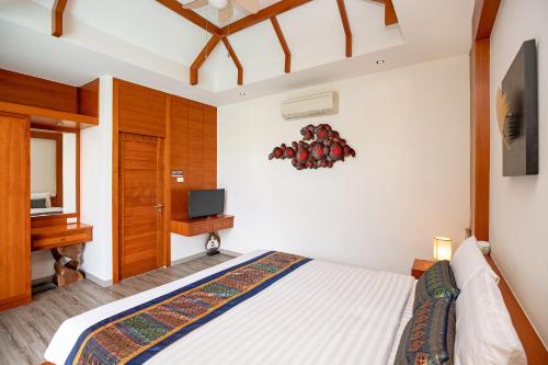 a bedroom with a bed and a television in it at Cozy 2Br Pool Villa Lexi*200m to Rawai Beach*Kids Park in Rawai Beach