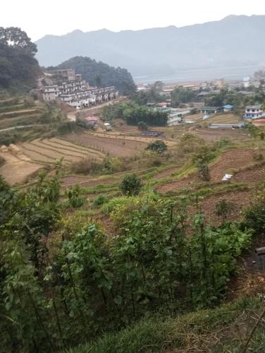 a view of a village from a hill at GAUTAM GARDEN GUEST HOUSE in Pokhara