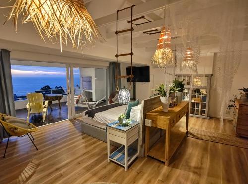 a bedroom with a bed and a living room at Sun&Sand Camps Bay in Cape Town
