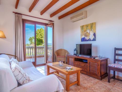 a living room with a couch and a tv at Apartment Finca Can Corritx-1 by Interhome in Muro
