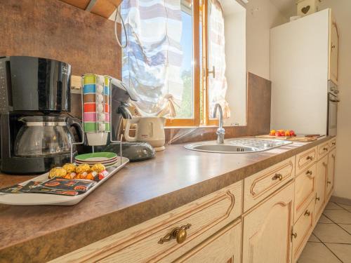 a kitchen counter with a sink and a microwave at Holiday Home Magali - HYE550 by Interhome in Hyères