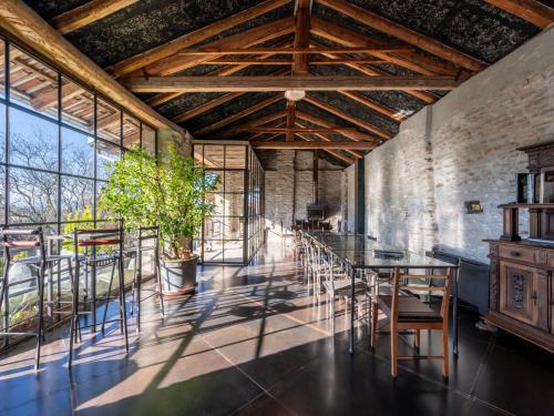 a room with a table and chairs and a plant at Holiday Home Antico Borgo del Riondino by Interhome in Trezzo Tinella