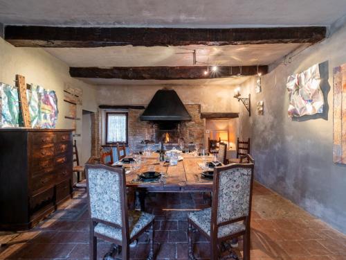 a dining room with a large wooden table and chairs at Holiday Home Borgo del Riondino by Interhome in Trezzo Tinella