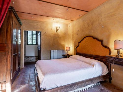 a bedroom with a large bed in a room at Holiday Home Borgo del Riondino by Interhome in Trezzo Tinella
