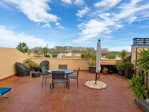 a patio with a table and chairs on a balcony at Apartment Novamar by Interhome in Puerto Marino