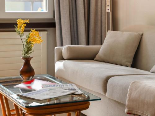 a living room with a couch and a glass table at Apartment Allod Park Haus B 202 by Interhome in Davos