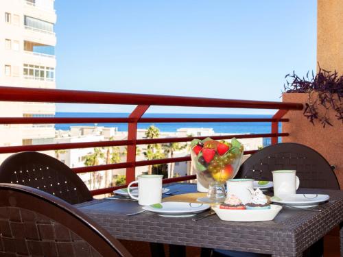 un tavolo con cibo e un cesto di frutta sul balcone di Apartment Riviera-1 by Interhome a Calpe